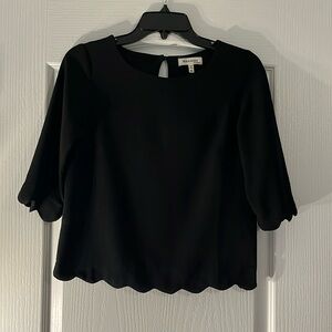Black blouse with scallop hem